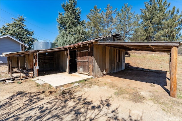 exterior space featuring a carport and an outdoor structure