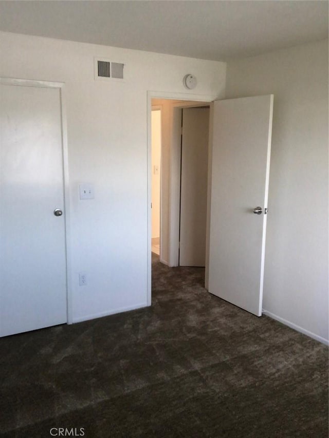 unfurnished bedroom featuring visible vents