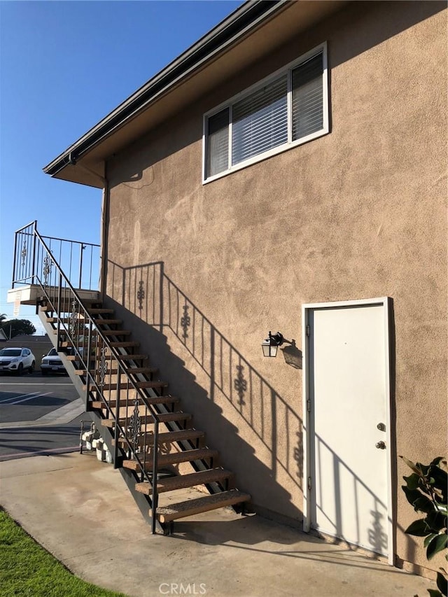 entrance to property featuring stucco siding