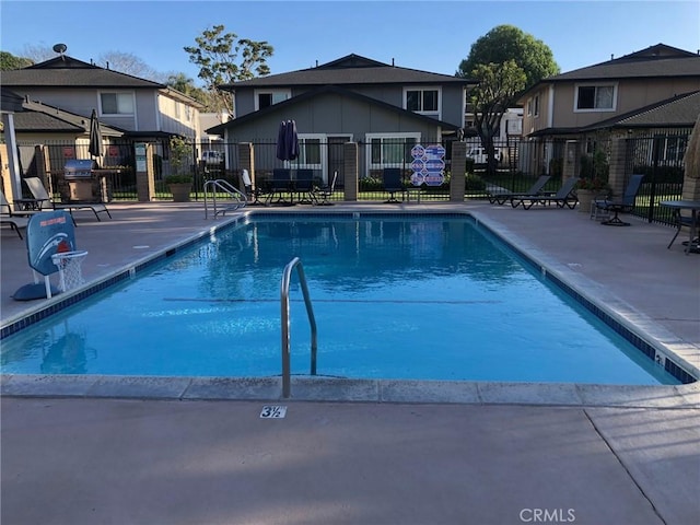 pool with fence and a patio