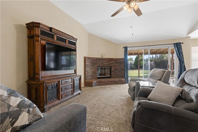 living area with lofted ceiling, a brick fireplace, carpet, and a ceiling fan