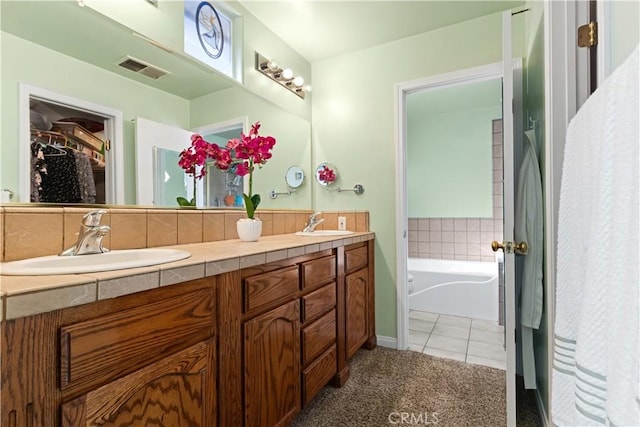 bathroom with double vanity, tile patterned flooring, a sink, and visible vents