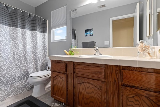 bathroom featuring a shower with shower curtain, visible vents, vanity, and toilet