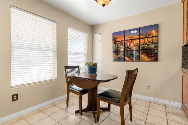 dining area featuring baseboards and light tile patterned flooring