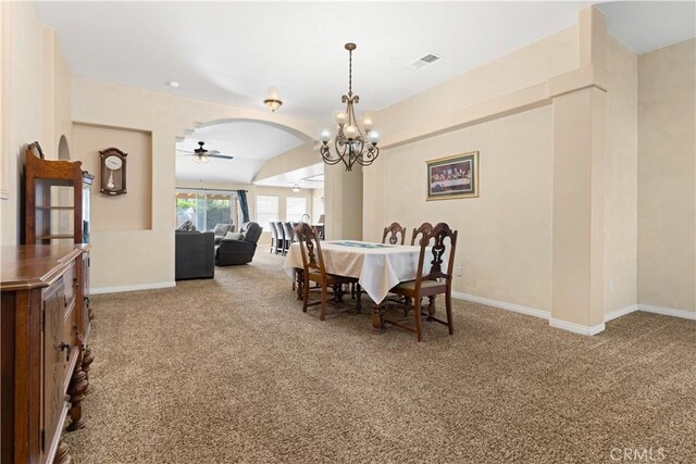 dining area with arched walkways, carpet floors, a ceiling fan, visible vents, and baseboards