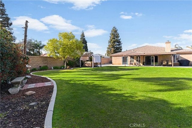 view of yard with a patio area and a fenced backyard