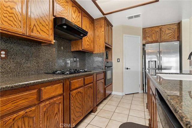 kitchen featuring light tile patterned flooring, under cabinet range hood, visible vents, backsplash, and black appliances