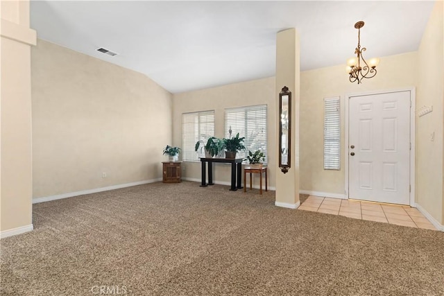 foyer entrance with light tile patterned floors, light carpet, visible vents, vaulted ceiling, and an inviting chandelier