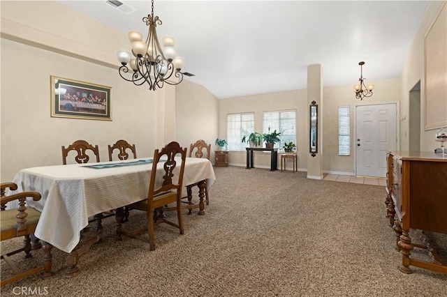 dining room with light carpet, visible vents, vaulted ceiling, and a notable chandelier