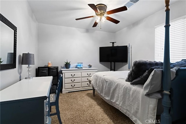 bedroom featuring a ceiling fan, visible vents, and carpet flooring