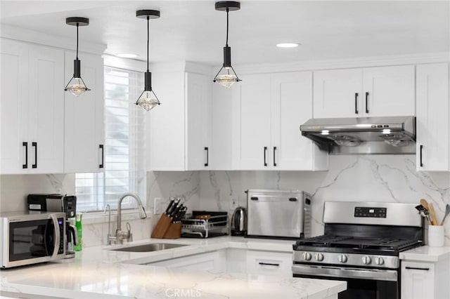 kitchen featuring appliances with stainless steel finishes, white cabinets, a sink, and under cabinet range hood