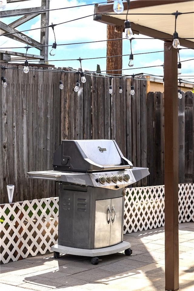 wooden terrace with a grill and fence