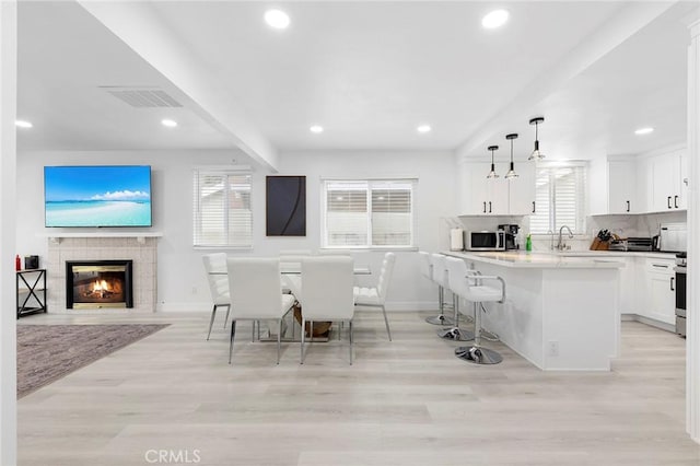 kitchen with a healthy amount of sunlight, light wood-type flooring, and appliances with stainless steel finishes