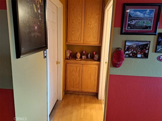19010 Waseca Rd, Apple Valley, CA 92307 - corridor featuring light wood-style flooring and a textured wall