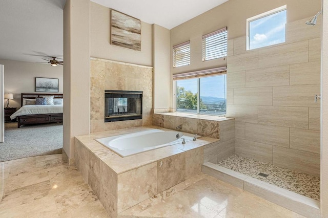 14797 Wild Colt Pl, Jamul, CA 91935 - bathroom featuring a garden tub, a tiled fireplace, ensuite bath, ceiling fan, and tiled shower