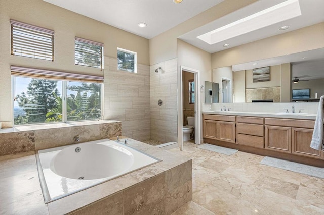 14797 Wild Colt Pl, Jamul, CA 91935 - bathroom with toilet, a garden tub, double vanity, a skylight, and a walk in shower