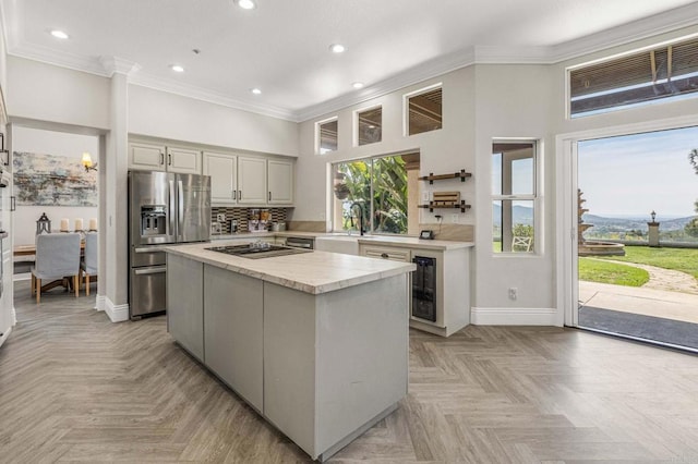 14797 Wild Colt Pl, Jamul, CA 91935 - kitchen with stainless steel refrigerator with ice dispenser, a center island, ornamental molding, recessed lighting, and a sink
