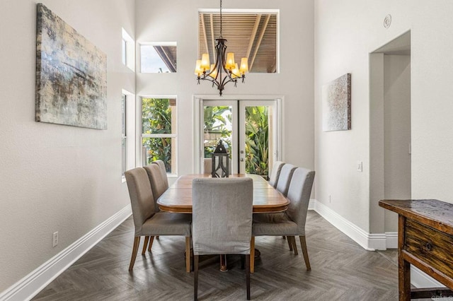 14797 Wild Colt Pl, Jamul, CA 91935 - dining space featuring a chandelier, baseboards, plenty of natural light, and a towering ceiling