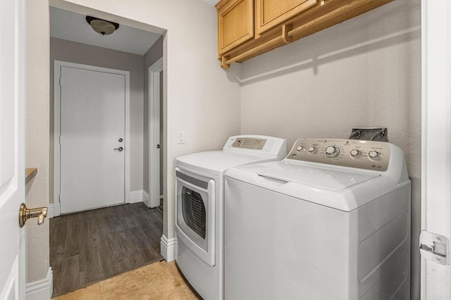 14797 Wild Colt Pl, Jamul, CA 91935 - washroom with independent washer and dryer, cabinet space, light wood-style flooring, and baseboards