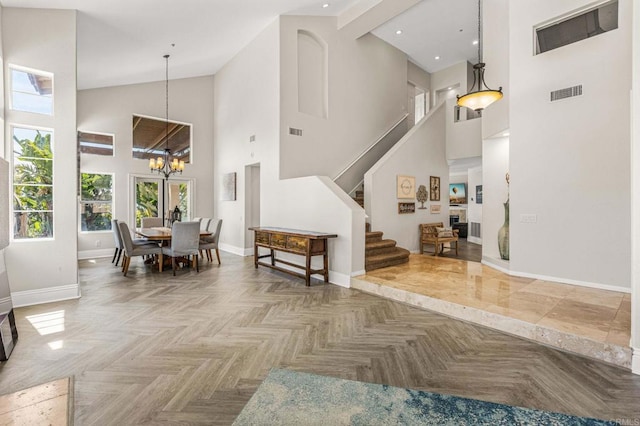 14797 Wild Colt Pl, Jamul, CA 91935 - living area with high vaulted ceiling, baseboards, a chandelier, stairs, and recessed lighting