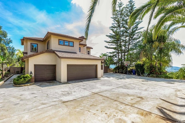 14797 Wild Colt Pl, Jamul, CA 91935 - mediterranean / spanish house with an attached garage, stucco siding, concrete driveway, and a tile roof