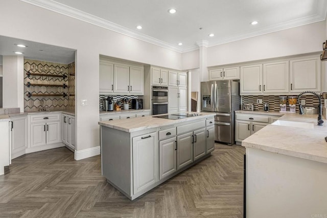14797 Wild Colt Pl, Jamul, CA 91935 - kitchen featuring appliances with stainless steel finishes, a center island, backsplash, recessed lighting, and crown molding
