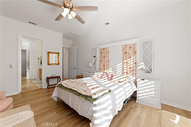 bedroom with light wood-style flooring, baseboards, and visible vents