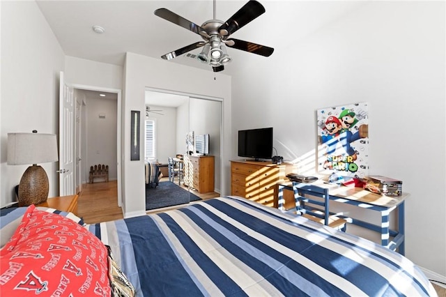 bedroom featuring a closet, baseboards, and ceiling fan