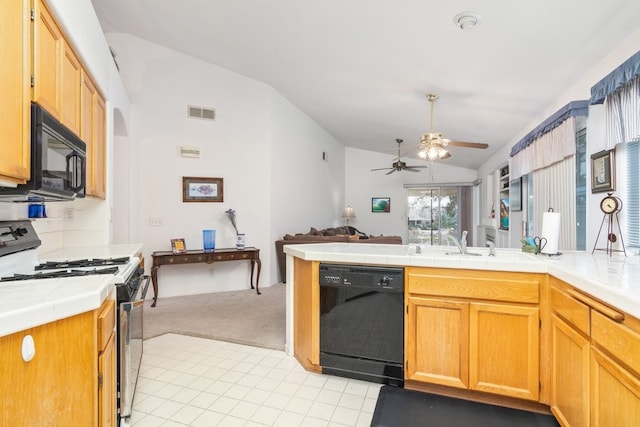 kitchen with tile counters, open floor plan, vaulted ceiling, arched walkways, and black appliances