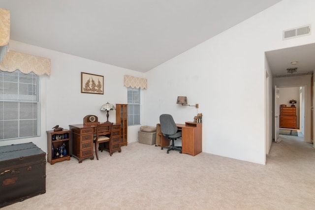 office area with visible vents, lofted ceiling, and carpet floors