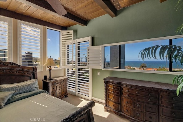 carpeted bedroom featuring beam ceiling, wood ceiling, and a water view