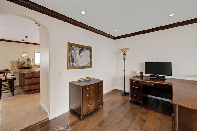 home office featuring baseboards, arched walkways, dark wood finished floors, and crown molding