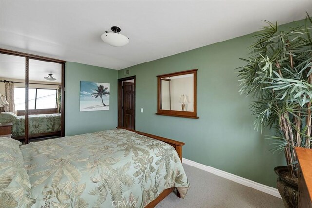 carpeted bedroom with baseboards