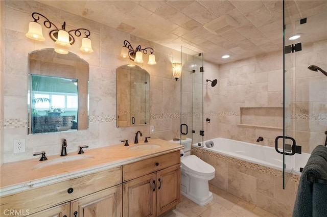 full bathroom featuring double vanity, tile walls, and a sink