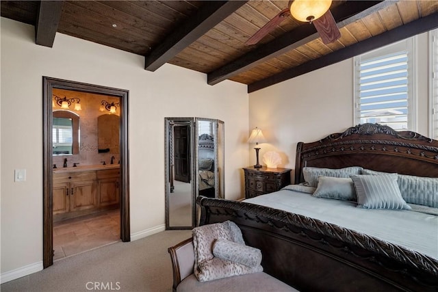 bedroom with baseboards, ensuite bath, beam ceiling, wood ceiling, and light carpet