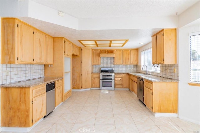 kitchen with stainless steel appliances, decorative backsplash, a sink, light tile patterned flooring, and light stone countertops