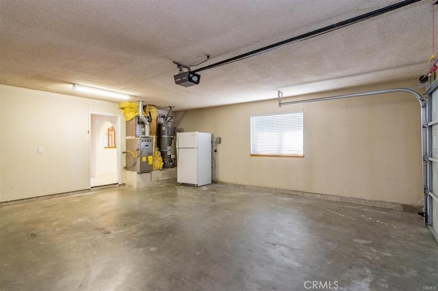 garage with a garage door opener, strapped water heater, and freestanding refrigerator
