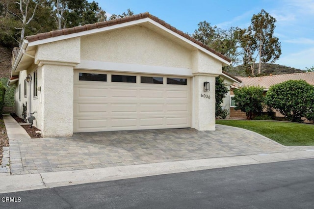 garage with decorative driveway