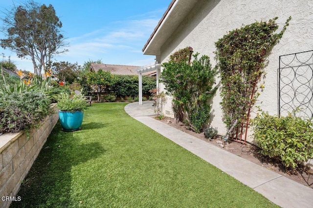 view of yard with fence and a pergola