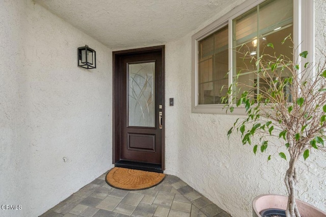 property entrance with stucco siding