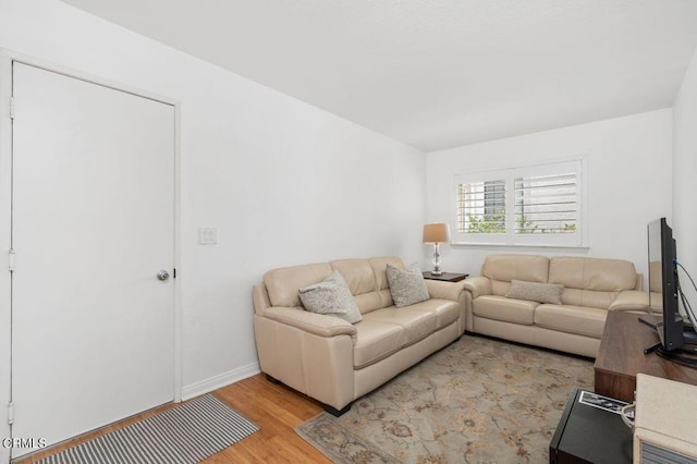 living area featuring light wood finished floors and baseboards