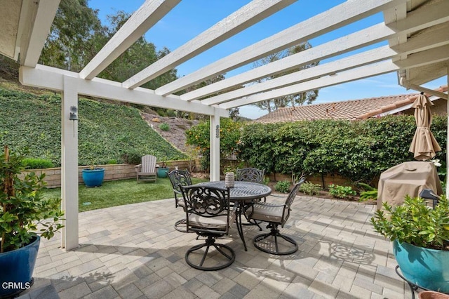 view of patio / terrace featuring outdoor dining area, a fenced backyard, and a pergola