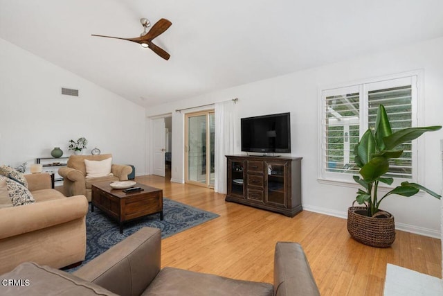living room featuring a ceiling fan, wood finished floors, lofted ceiling, and baseboards