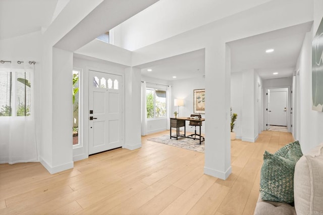 foyer featuring light wood-type flooring, baseboards, and recessed lighting