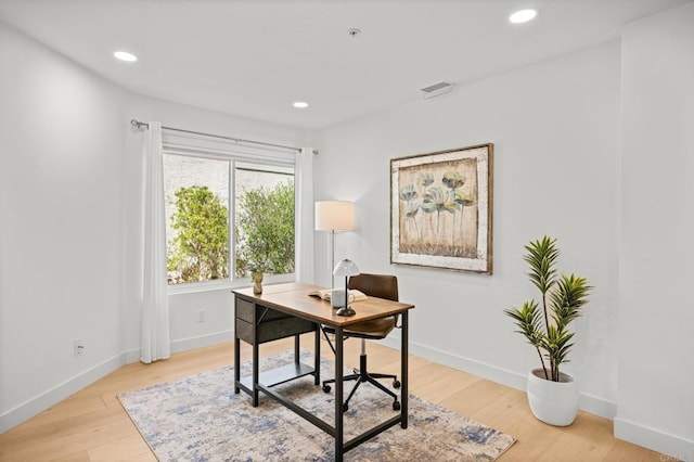 office area with light wood finished floors, visible vents, baseboards, and recessed lighting