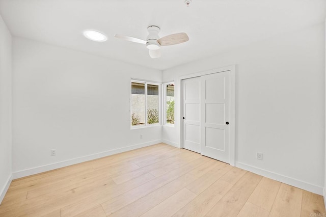 unfurnished bedroom featuring a ceiling fan, baseboards, and wood finished floors