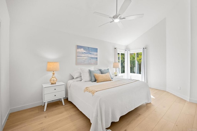 bedroom with vaulted ceiling, light wood-style flooring, and baseboards