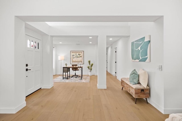 foyer with recessed lighting, light wood-style flooring, and baseboards