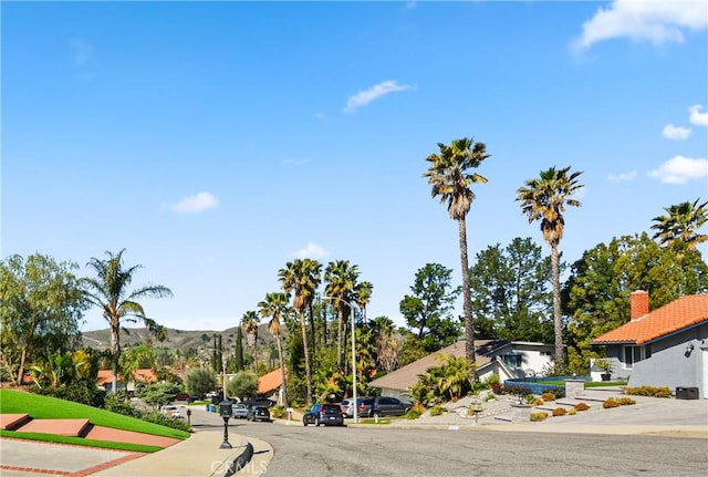 view of road featuring sidewalks and a mountain view