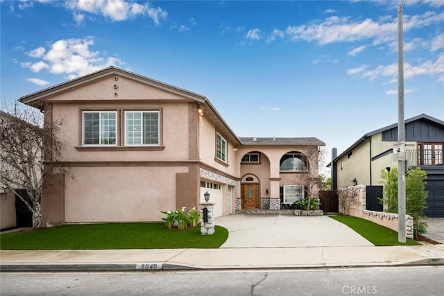 view of front of property featuring stucco siding, a front lawn, fence, concrete driveway, and an attached garage